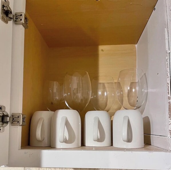 A storage unit with multiple wine glasses and their holders.