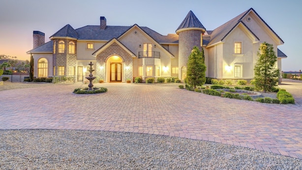 A large, multi-story house with a central entrance, a tower, and a well-maintained driveway. - The Castle-Pool/Spa/Billiard (Henderson)