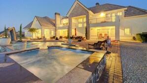 A large, two-story house with a swimming pool and outdoor seating area. - The Castle-Pool/Spa/Billiard (Henderson)