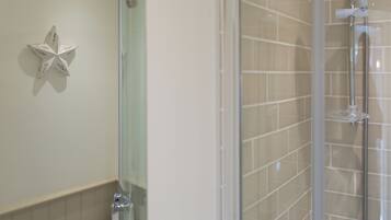 A bathroom with a shower, a toilet, and a wall-mounted star decoration.