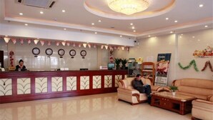 A hotel lobby with a reception desk, seating area, and decorative elements. - Runyang Jiayue Hotel (Dalian Jinzhou Railway Station) (Dalian)