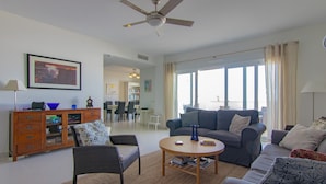 A living room with a sofa, armchair, coffee table, and a ceiling fan. - Villa 'Casa Flores 047' with Sea Views, Wi-Fi and Air Conditioning (Almayate)