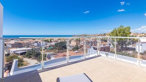 A balcony with a view of a coastal town, a clear sky, and a distant sea. - Villa 'Casa Flores 047' with Sea Views, Wi-Fi and Air Conditioning (Almayate)