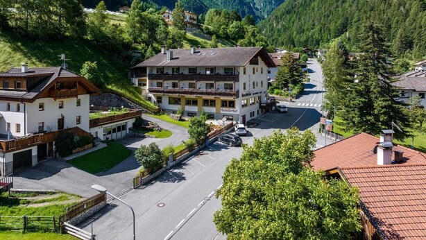 A mountain village with a prominent hotel featuring a balcony, a parking area, and lush greenery. - Apartment 'Martellerhof - Opis Pennhaus Small' with Sea View, Shared Terrace and Wi-Fi (Martell)