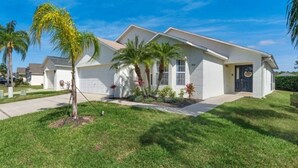 A single-story house with a garage, a front porch, and a well-maintained lawn.