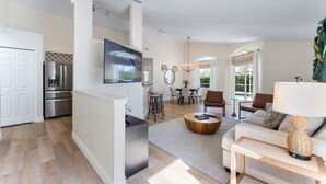 A modern living space with a kitchen, dining area, and seating area.