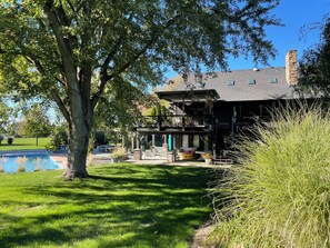 A two-story house with a covered patio and a swimming pool. - Spacious 4-bedroom house in lovely Walla Walla with pool and fitness room (Walla Walla)