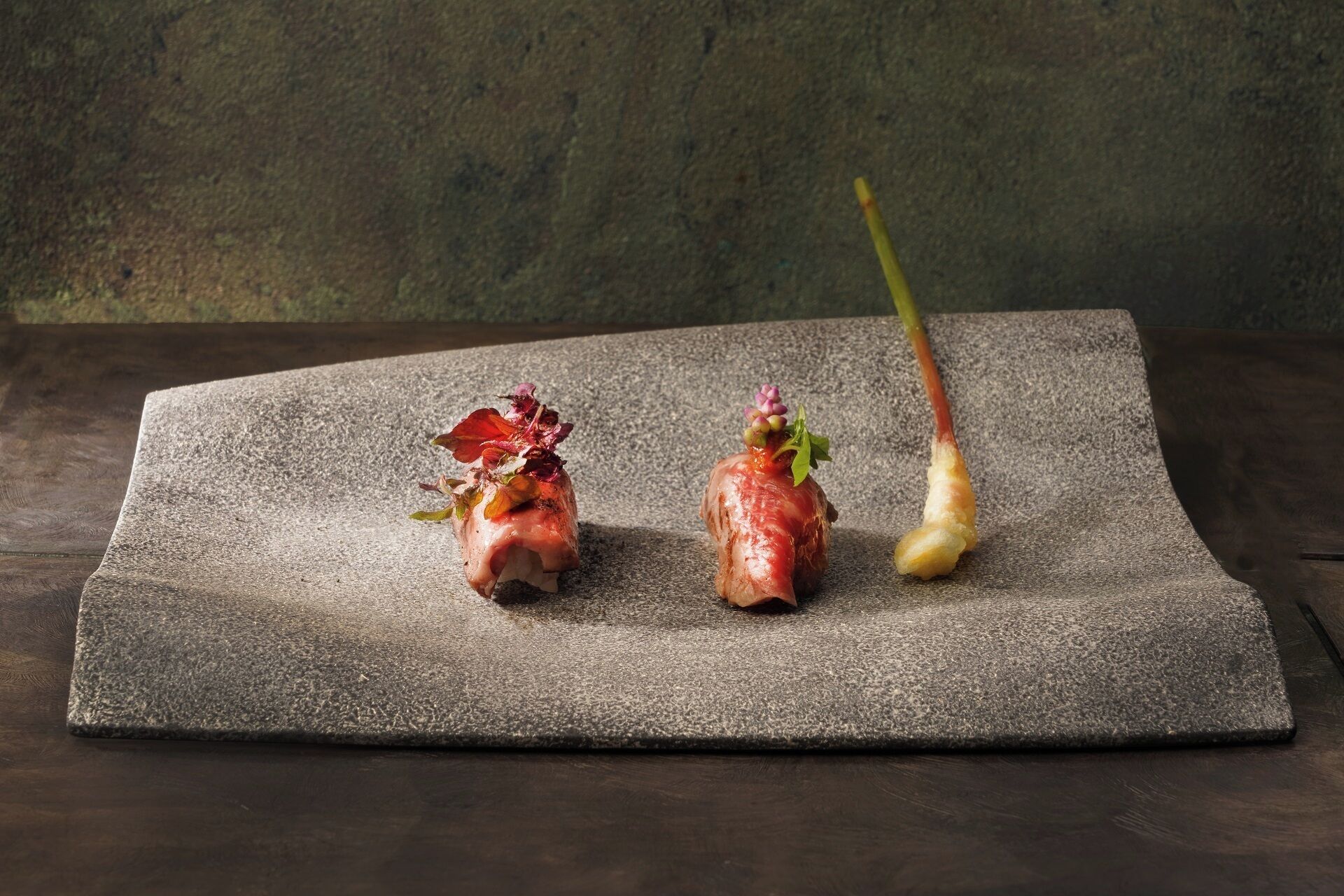 A stone table with three food items.