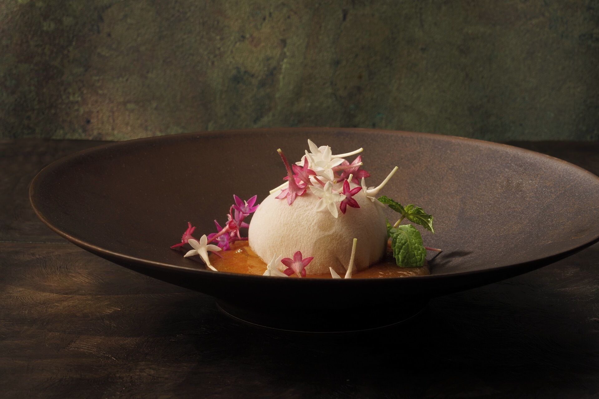 A dessert on a dark plate with a textured background.
