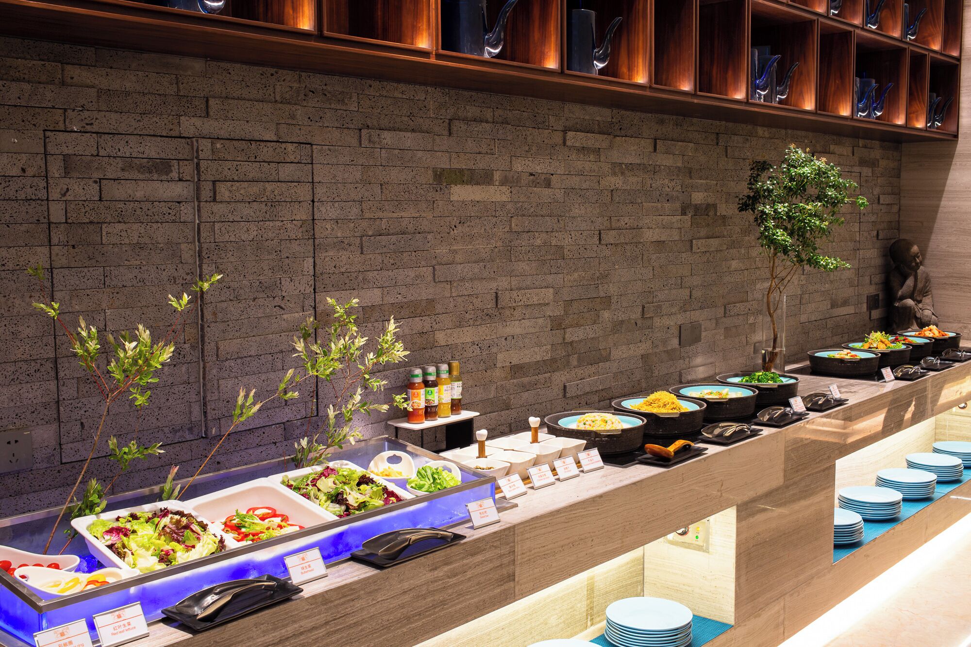 A buffet setup with various dishes and condiments.