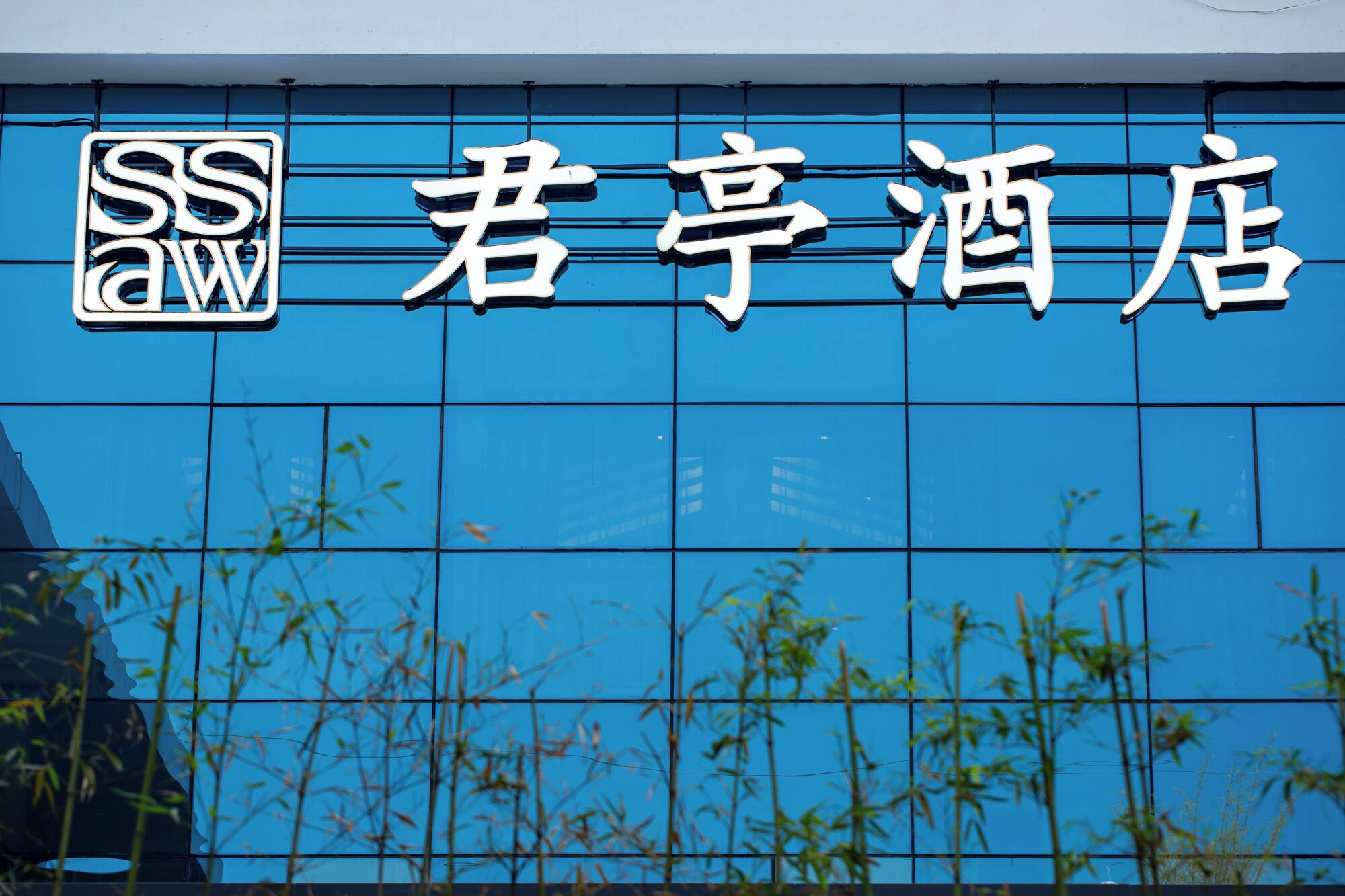 Een hotelschild met Chinese karakters en een logo.