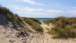 A sandy path leading to the sea, surrounded by grass. - "Kristiarn" - 1.1km from the sea by Interhome (Aakirkeby)