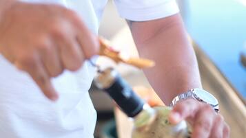 A person pouring a drink from a bottle into a glass.