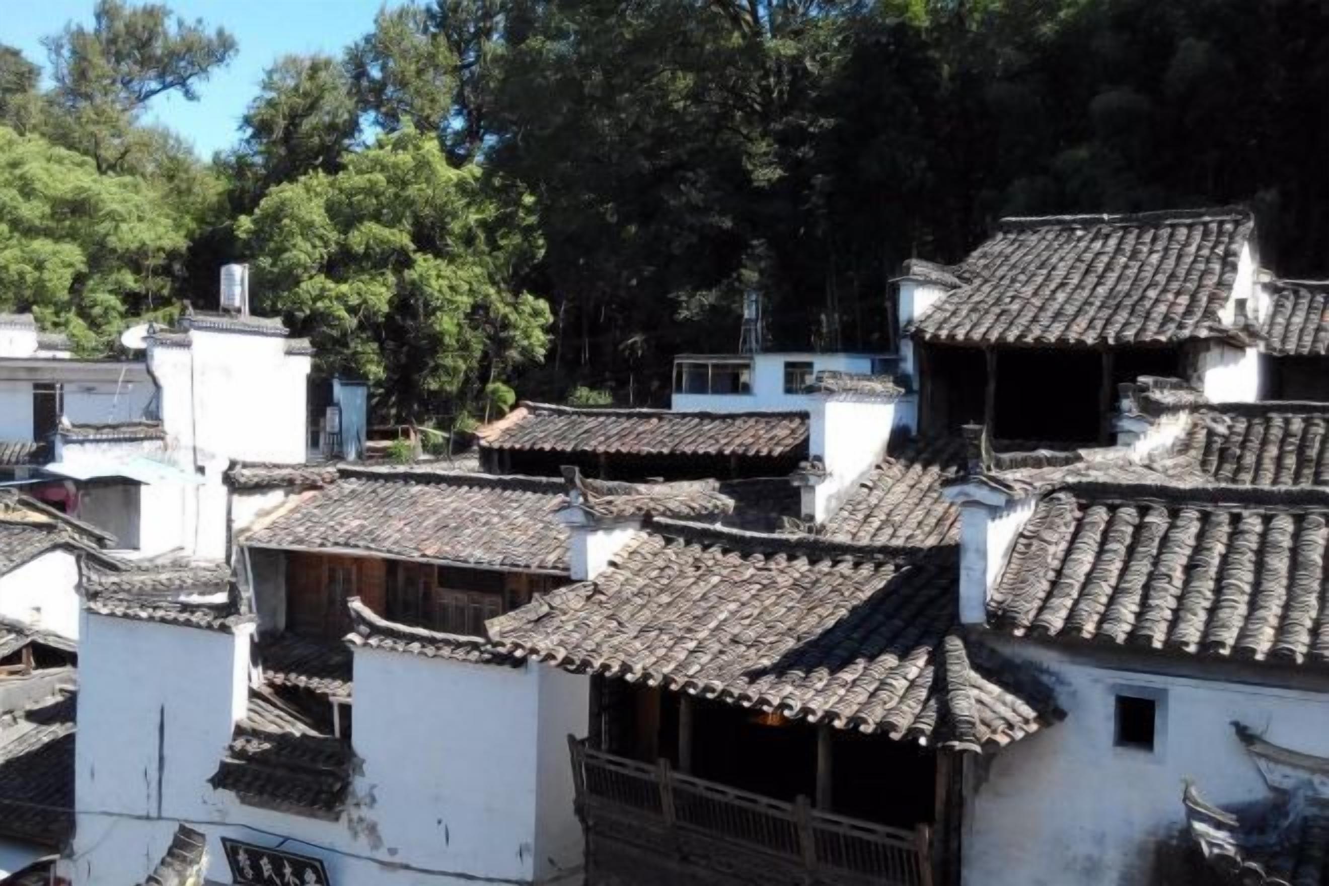 A traditional building with multiple levels, steeply pitched roofs, and a dense arrangement of windows.