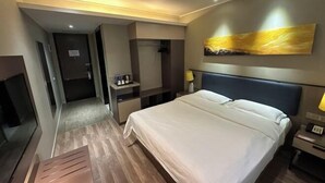 A hotel room with a large bed, a desk, a chair, a TV, and a painting on the wall. - Ease Hotel (Beijing Liangxiang University Town) (Beijing)