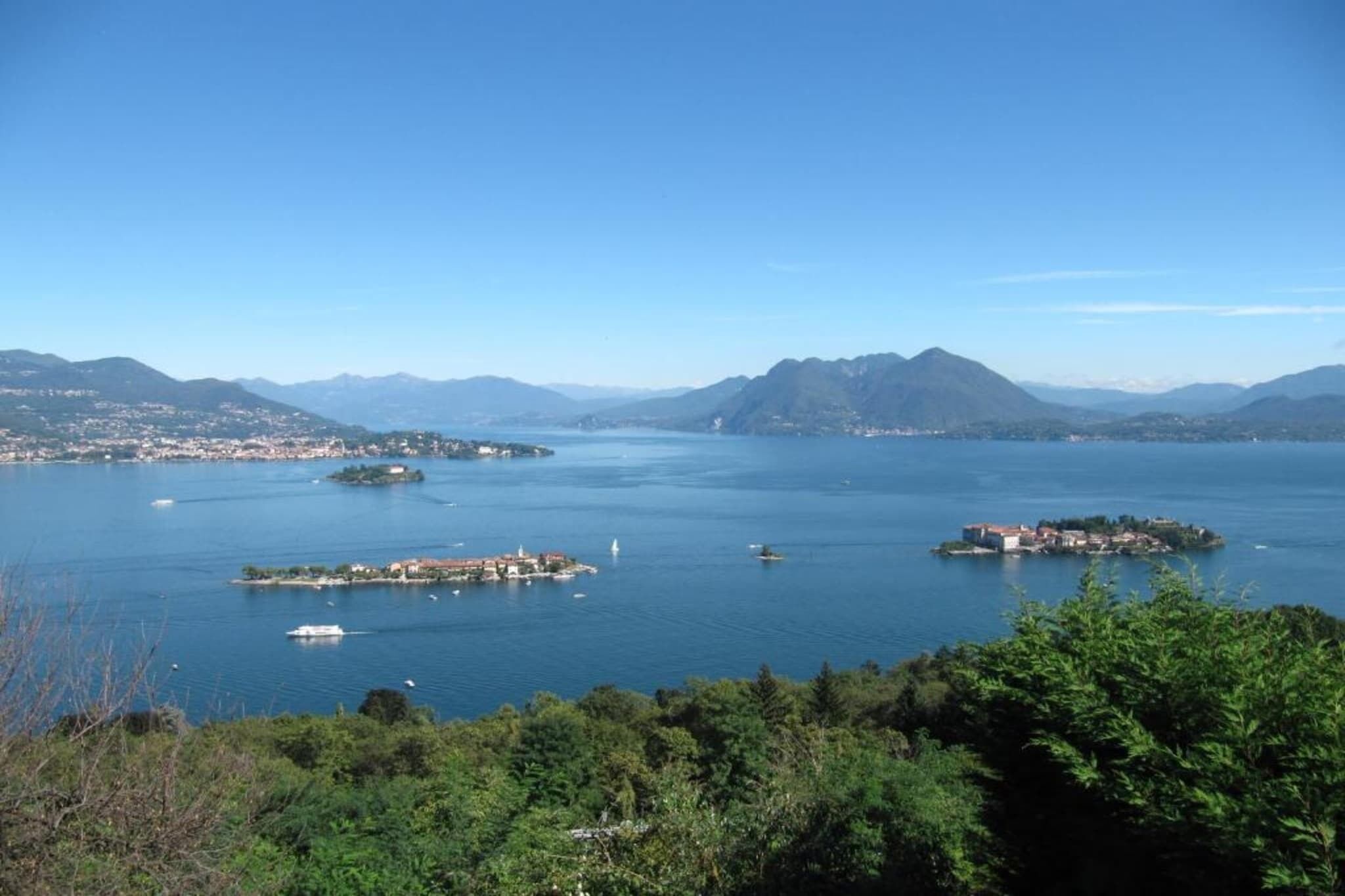 A coastal landscape with multiple islands and a clear blue sky.