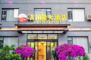 A hotel with a prominent entrance, a sign with Chinese characters, and a JBL logo.