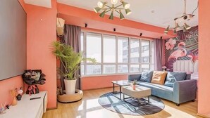 A living room with a sofa, coffee table, and a large window.