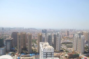 A high-rise building complex with multiple residential and commercial structures, surrounded by a cityscape. - Qingdao Lanting Holiday Apartment (Qingdao)