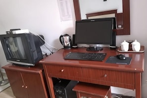 A wooden desk with a computer monitor, keyboard, mouse, and a television. - Xinping Credibility Hotel (Xinping)