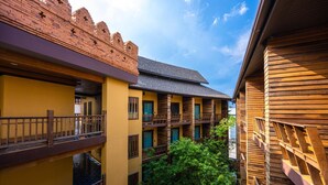 A multi-story building with balconies and a courtyard. - At Gate Thaphae Hotel (Chiang Mai)
