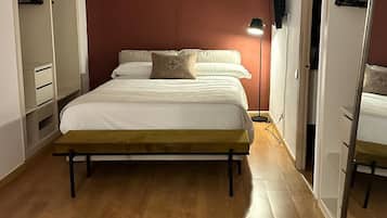 Una camera da letto con un letto, un armadio e uno specchio.