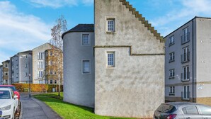 A residential building with a unique architectural design, featuring a prominent staircase and multiple windows. - 17th Century Dovecot, 20 min to Edinburgh by train (Inverkeithing)