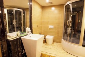 A modern bathroom with a glass-enclosed shower, a white sink, and a marble-tiled floor. - Chengjiang Manor Hotel (Chengjiang)
