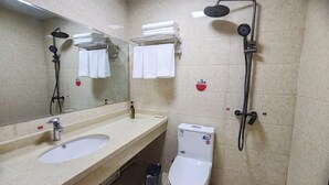 Un baño con dos lavamanos, un inodoro, una ducha y un espejo.