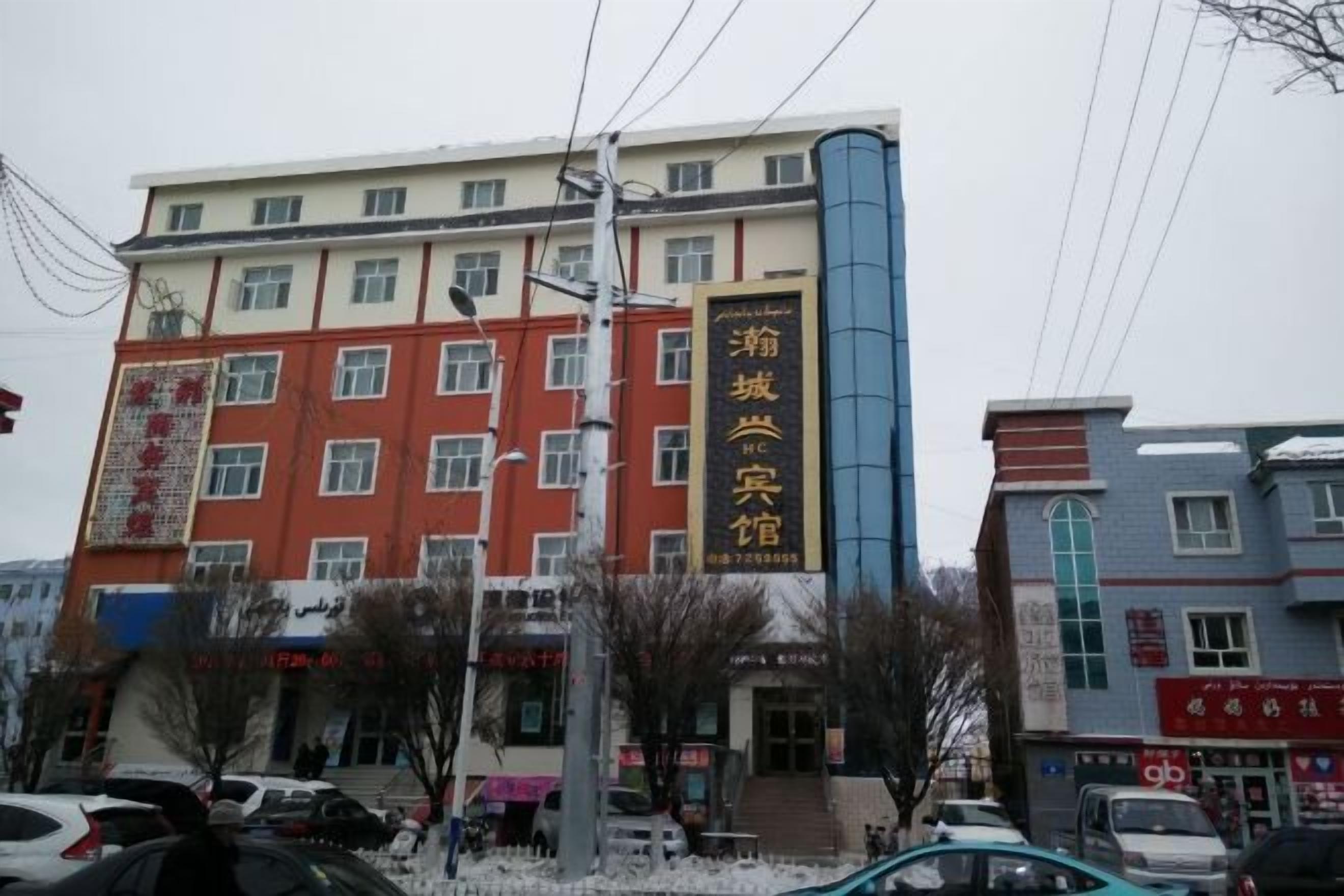 A multi-story building with a prominent sign for a hotel.