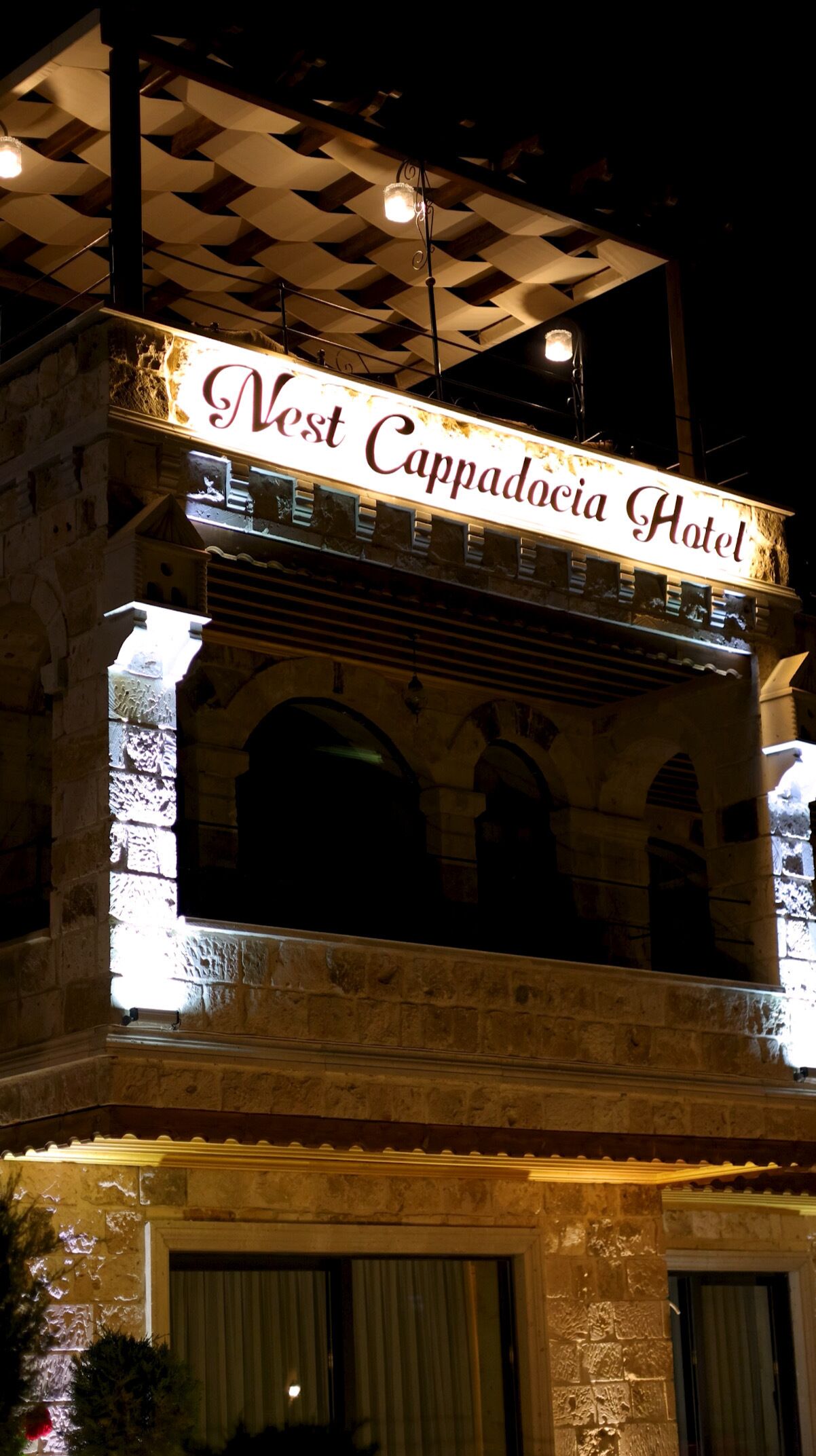 The exterior of the Nest Cappadocia Hotel with a prominent illuminated sign.