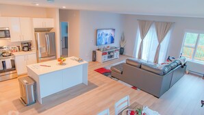 Un espacio habitable moderno con cocina, comedor y un sofá grande.