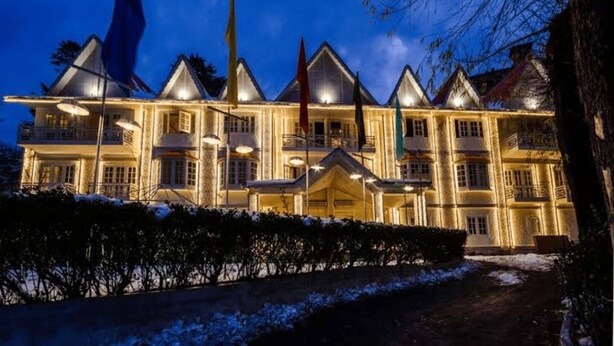A large, multi-story building with a symmetrical facade, multiple balconies, and a central entrance. - Hotel Snow Princess  (Manali)