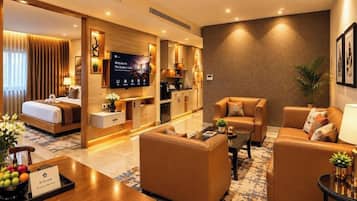 A hotel room with a bed, a sofa, a coffee table, a TV, and a reception desk.