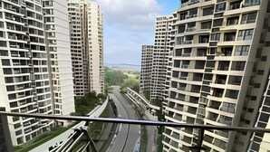 A high-rise residential building with multiple floors, large windows, and a view of a road and greenery below. - SeaView Country Garden 3BR2FREE By Natol (Johor Bahru)