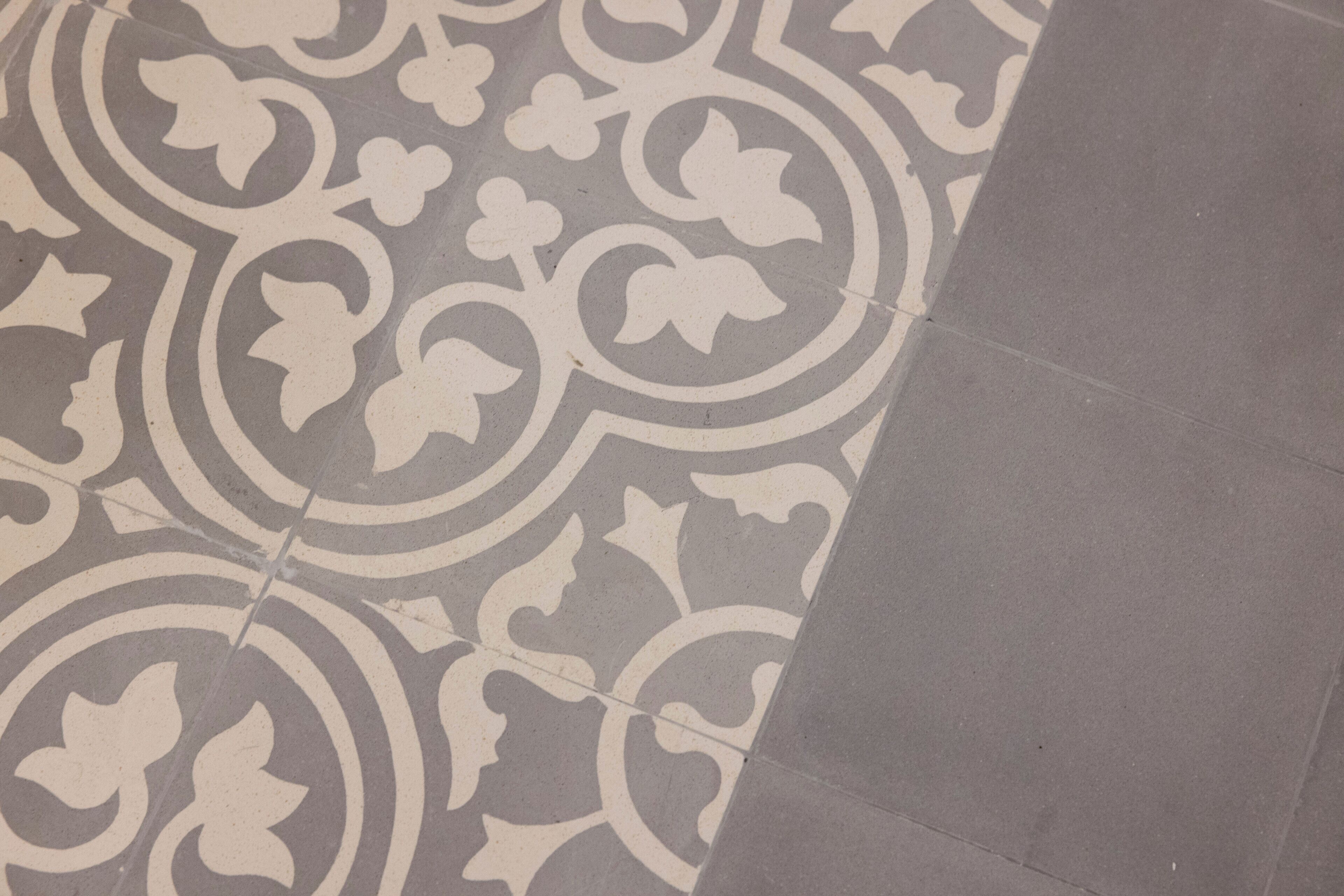 A section of a floor with a patterned tile design.
