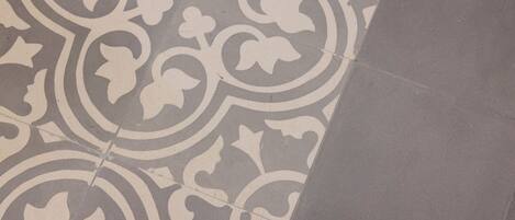A section of a floor with a patterned tile design.