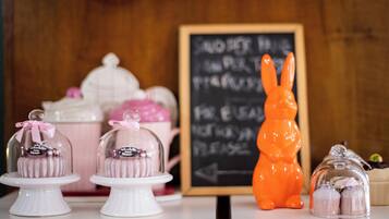 A display of desserts with a sign that reads "NO EATING PLEASE."