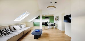 A modern apartment with a loft-style living area, a dining space, and a kitchen. - Bright & Stylish Two-Bedroom Apartment with Modern Comforts in Saint-Germain (Paris)