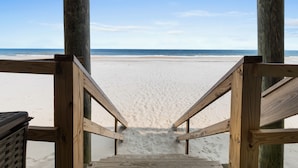 A wooden staircase leading to a beach with a clear sky. - 6-Bedroom Beach House w/ Private Dock & Pool in Inlet Harbour (Murrells Inlet)