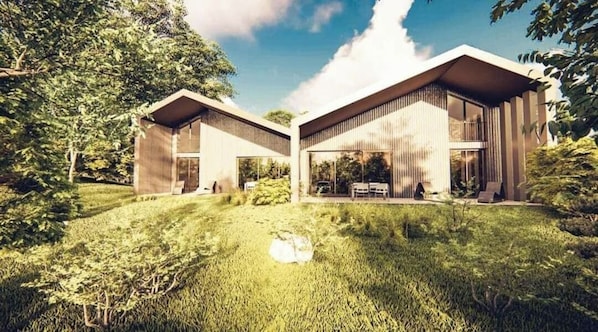 A modern two-story house with a flat roof, large windows, and a grassy yard.