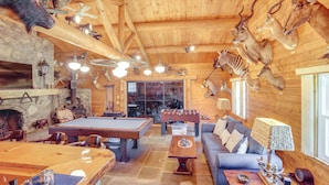 A wooden interior with a pool table, seating area, and various mounted animal heads. - Pond & Hot Tub! Airy Hudson Valley Escape (Austerlitz)