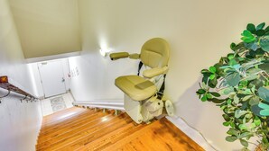 A wooden staircase leading to a room with a toilet and a potted plant. - 2 Mi to Warren Dunes - Bright Sawyer Apartment! (Sawyer)