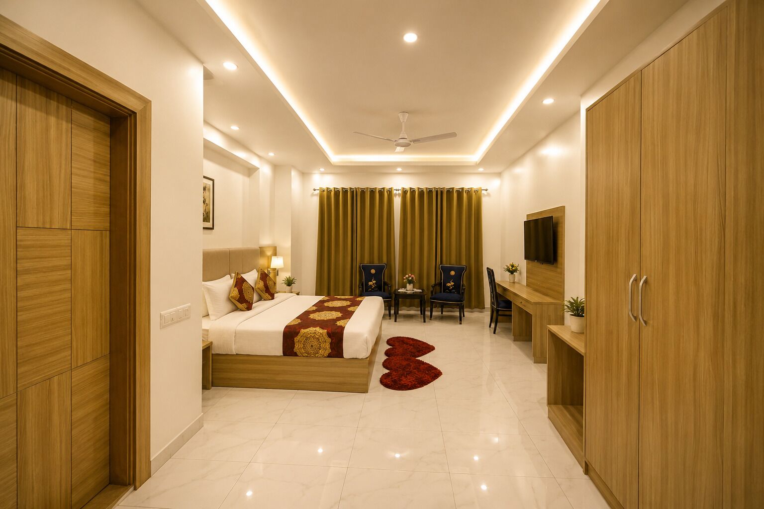 A hotel room with a bed, a desk, a chair, a TV, and a wardrobe.