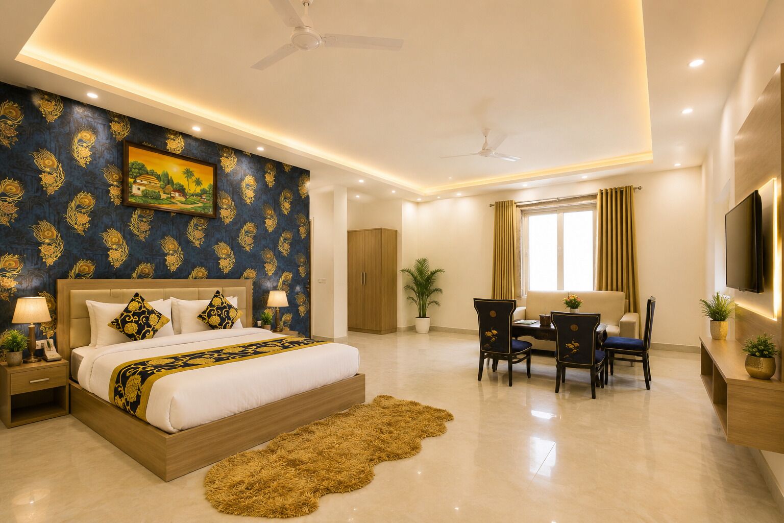 A hotel room with a bed, a desk, chairs, a television, and a ceiling fan.