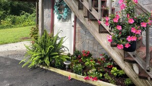 A wooden staircase leading to a house with a stone facade. - Charming and immaculate 1-bedroom Suite/Apartment in Elizabethton  (Elizabethton)