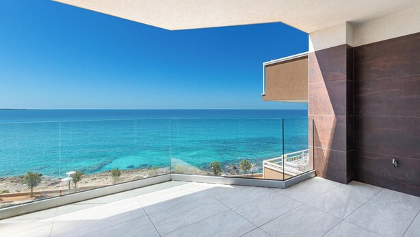 A balcony with a clear view of the sea, a tiled floor, and a modern door. - 4009 Attico Smeraldo by Perle di Puglia (Gallipoli)