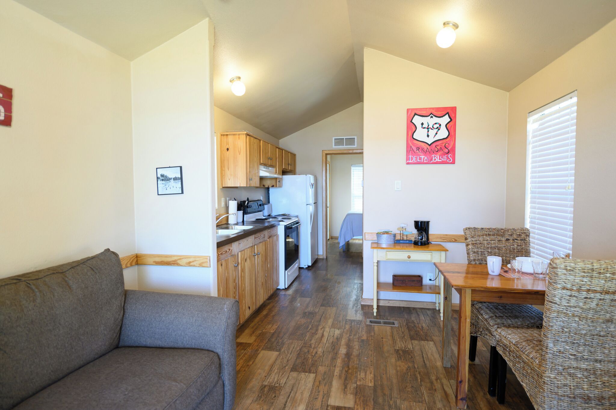 A compact living space with a kitchenette, a dining area, and a seating area.
