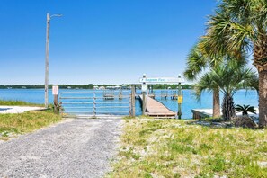 A gated entrance to a waterfront property with a sign reading "Lagoon Pass". - Lagoon Front | Boat Launch, Pier and Beach Access | Pet Friendly (Gulf Shores)