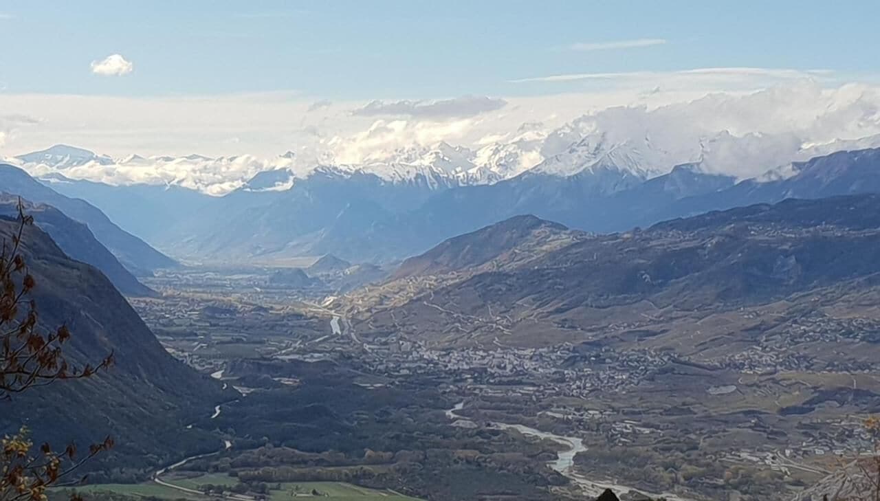 A mountainous landscape with a valley and a river.